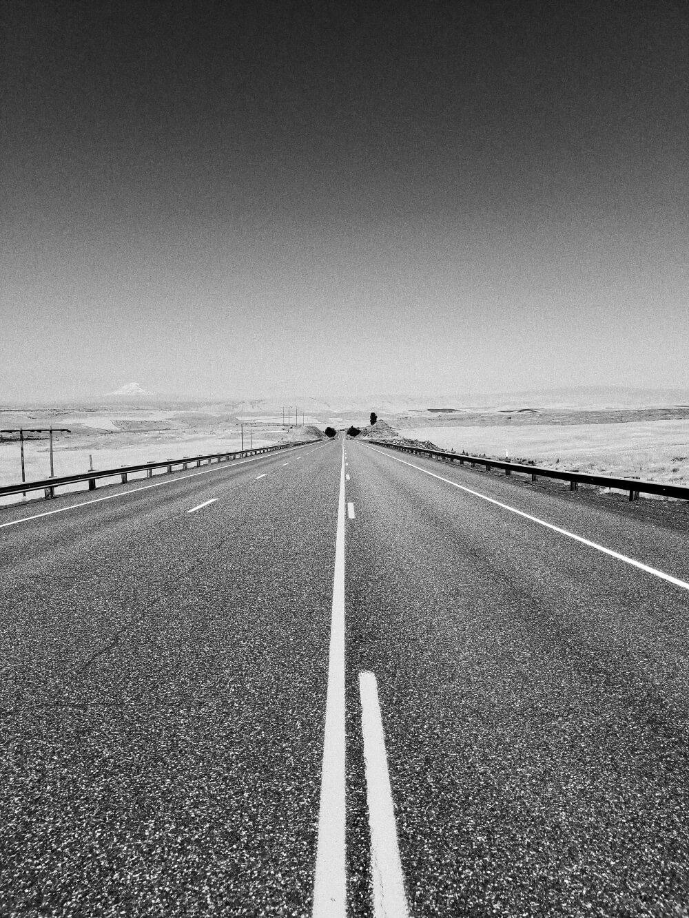 Photo shows a long stretch of highway heading into the distance. A potential market for Ekona's carbon black is in the asphalt used to pave roads.