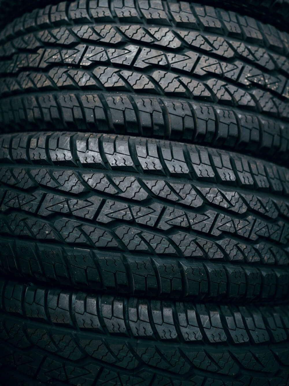 Photo shows stacked tires. Tires and rubber are an important market for Ekona's carbon black.